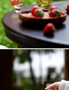 Detailed close-up of heat-resistant glass tea pot with wood tray and fresh strawberries.