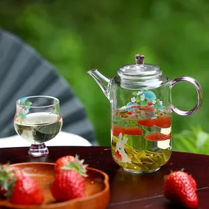High borosilicate glass teapot with cute strawberry and rabbit pattern, heat resistant design.