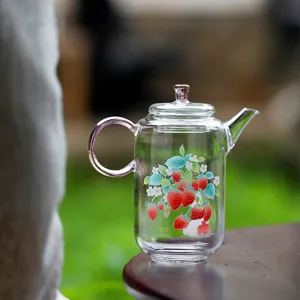 Clear glass teapot with pink handle and sweet strawberry pattern design for home tea time