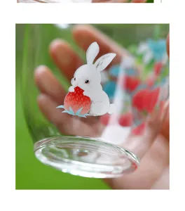 Close-up detail shot of the clear glass cup featuring a cute rabbit and strawberry pattern.