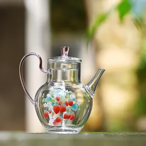 Clear glass teapot with strawberry bunny motif, pink handle, heat-resistant borosilicate glass.