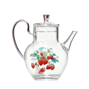 Clear glass teapot with lovely strawberry pattern and pink handle for daily tea brewing.
