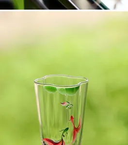 Dettaglio in primo piano della tazza in vetro borosilicato con motivo di loto e pesci.