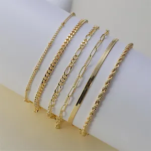 Detail view of multi-style layered gold chains anklet set, minimalist fashion design jewelry.