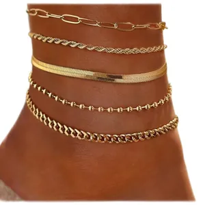 Gold layered anklet set featuring multi-style chains like paperclip, snake, and cuban links.