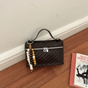 Dark brown woven box handbag for women, stylish top handle vanity bag with beaded charm.
