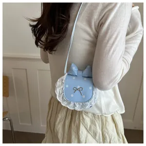 Close-up detail of the cute light blue polka dot crossbody bag with delicate lace trim.