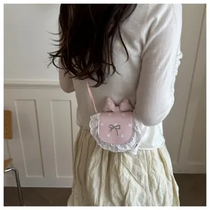 Cute pink polka dot mini crossbody bag with delicate lace trim and sweet bow detail.