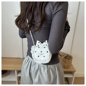 Detail shot of cute mini polka dot crossbody bag with lace bow for sweet daily autumn outfits.