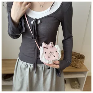 Close-up of cute pink polka dot mini crossbody bag with delicate lace trim and bow accent.