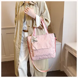 Pink star pattern canvas tote bag with front pocket and adjustable shoulder strap for daily use.
