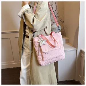 Stylish large capacity pink star print tote bag with shoulder strap and star charm detail.