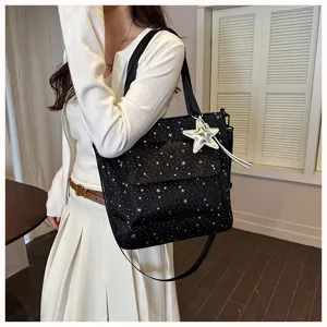 Detailed view of stylish black star-printed large capacity tote bag with silver star pendant.