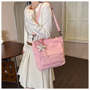 Pink corduroy tote bag detail showing soft fabric texture, shoulder strap and starfish pendant.