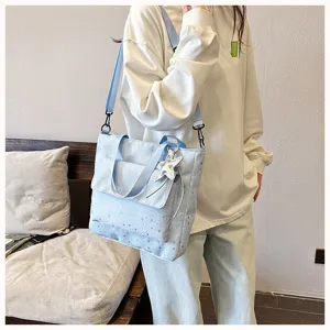 Light blue star pattern tote bag detail shot, large capacity canvas shoulder bag with star pendant.