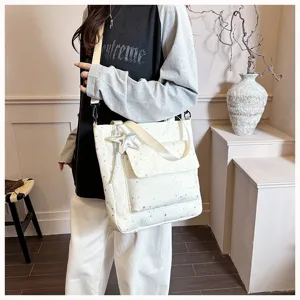 Versatile large capacity white star print tote bag with front pocket and shoulder strap.