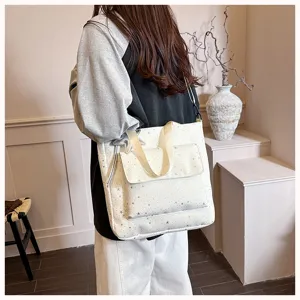 Stylish large capacity tote bag for women, casual commuter shoulder bag with star pattern details.