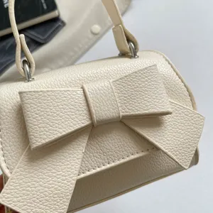 Cute mini princess handbag for girls, solid color bow crossbody bag, stylish children's bag.