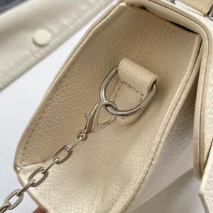 Chic mini girls shoulder handbag with solid color and delicate metal chain strap design.