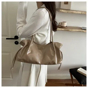 Chic glossy leather shoulder bag with stylish drawstring details, perfect for daily commute and style.