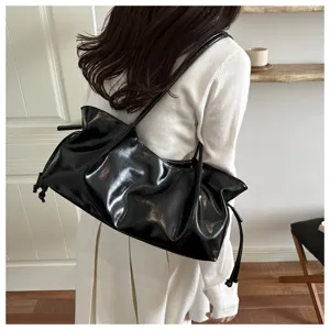 Glossy black patent leather shoulder baguette bag, stylish daily commuting handbag for women.