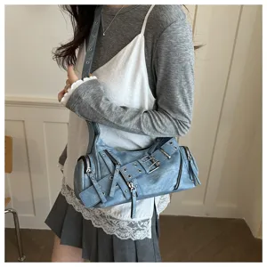 Detail view of the vintage blue motorcycle shoulder bag featuring stylish metal buckles.