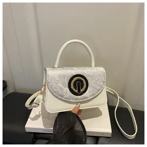 Elegant white underarm shoulder bag with chic textured flap and round clasp for daily commute