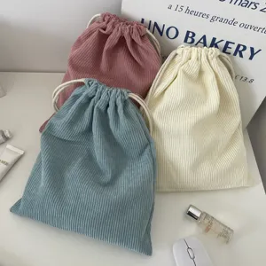Corduroy drawstring pouch set in pink white and blue color close-up