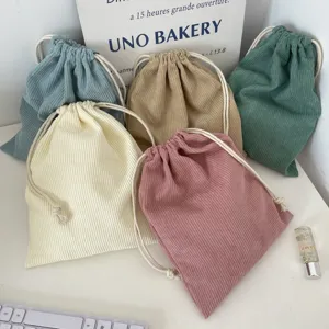 Assorted solid color corduroy drawstring bags for makeup storage and travel needs