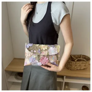 Floral embroidered chain crossbody bag detail view, elegant evening shoulder bag for women use.