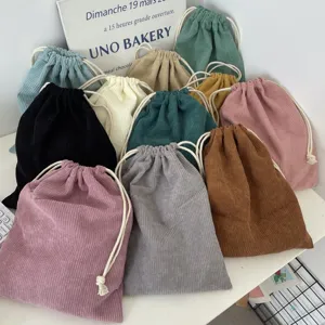 Collection of multi-color corduroy drawstring storage pouches with visible fabric texture