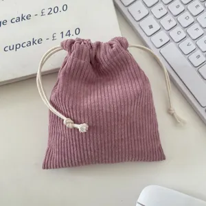 Detailed macro view of a mauve corduroy drawstring storage bag with soft ribbed texture