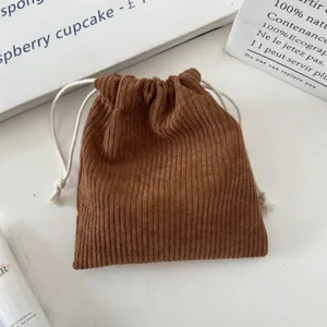 Close-up of brown corduroy drawstring pouch with white ropes