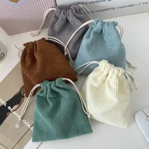 Corduroy drawstring storage pouches in multiple solid colors shown in a stack