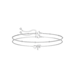 Detailed view of a silver double layer charm bracelet featuring a cute heart and letter F pendant.