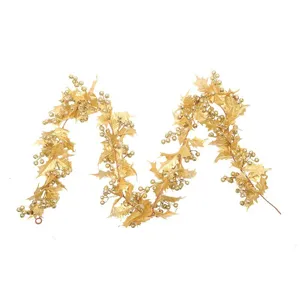 Elegant golden Christmas garland with metallic holly leaves and berries for home holiday decor