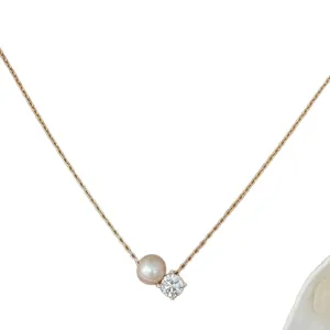 Elegant gold-tone chain necklace featuring a delicate pearl and sparkling rhinestone pendant.