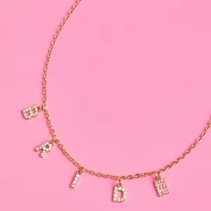 Detailed closeup of the gold rhinestone BRIDE letter charm necklace, ideal as a bridesmaid gift.