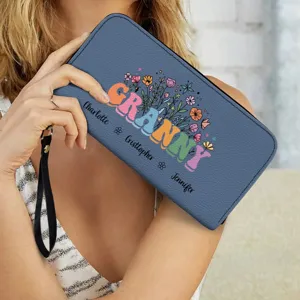 Close-up detail shot of a custom printed blue PU leather wristlet wallet with floral design.