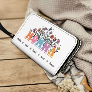 Detail view of custom white leather zipper wallet with floral MOMMA and family names.