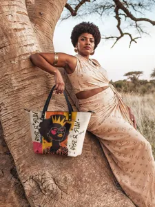 Detailed view of fashionable PU leather tote bag with African girl print in outdoor setting