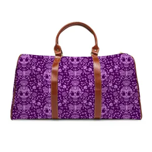Stylish purple skull and rose travel duffel bag with brown leather handles for gym and trips.