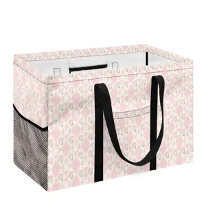 Panier à linge pliable rose motif lapin et tulipe avec poignées noires et poches filet.