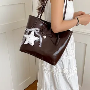 Brown patent leather tote shoulder bag for women with cute star pendant and bow decoration.