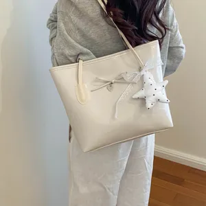 Women stylish white tote bag with bow and star pendant, versatile casual shoulder handbag.