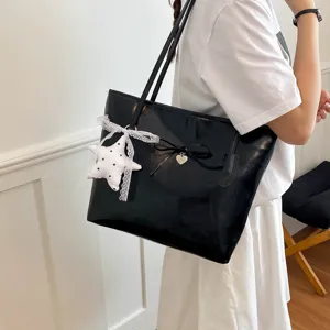 Chic black tote bag for women with cute bow and star pendant, ideal for daily stylish commuting.