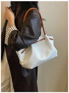 Elegant white hobo shoulder bag for women, stylish French design with brown leather straps.