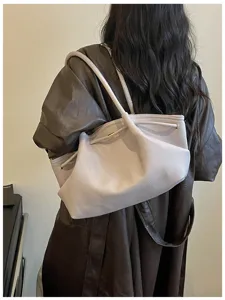 Detailed view of stylish French design large capacity shoulder hobo bag in light gray leather.