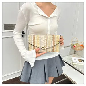 Detailed shot of a stylish multi-color woven envelope clutch bag, featuring a chic metal clasp.