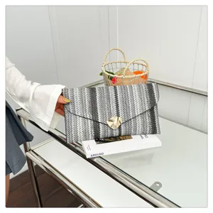 Stylish women woven clutch bag with striking contrast stripes and elegant metallic closure for daily wear.